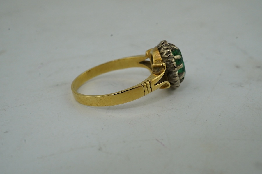 A yellow metal, emerald and diamond cluster set oval ring, size M and a pair of matching ear studs. Condition - poor to fair